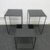 Set of 3 Black Assorted Sized Metal Framed Display Tables with Black Glass Insert to Include 2 x H65cm x W43cm x D43cm & 1 x H45cm x W43cm x D43cm.