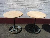 Pair of Oak Top Circular Tables on Heavy Cast Iron Industrial Wheel Base. Size H76cm x Dia 70cm.