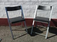 Pair of Grey Metal Folding Chairs with Black Faux Leather Seat. 