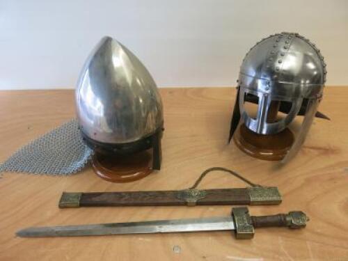 3 x Items of Replica Armour to Include: 2 x Helmets on Wooden Plinths & Sword with Scabbard.