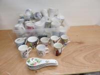 57 x Assorted China Mugs in Assorted Styles, Patterns & Designs & 5 x Tea Spoon Drainers (As Viewed/Pictured).