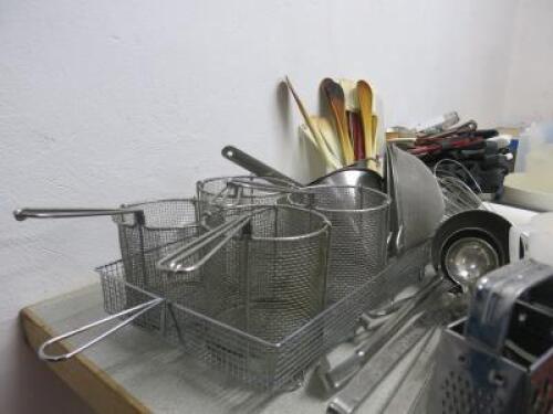 Large Lot of Commercial Kitchen Accessories to Include:Sieves, Ladles, Whisks, Frying Baskets,Spatulas, Wooden Spoons, Tongs,Measuring Jugs, Rolling Pins, Cake Slice,Vegetable Cutters (as Viewed/Pictured).