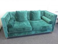 2 Seater Sofa, Upholstered in Emerald Chenille Material with Silver Coloured Studs. Comes with 2 Square & 2 Cylindrical Matching Cushions. Size H79cm x W180cm x D83cm.