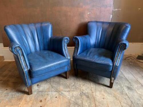 Pair of High Back Armchairs Upholstered in Blue Faux Leather with Stud Detail and Wooden Feet. Size H74cm x W72cm x D80cm. NOTE: repair to 1 x foot (As Viewed/Pictured).