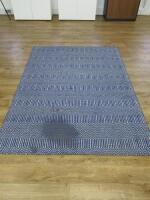 163 x 230cm Blue & White Patterned Rug. NOTE: requires cleaning.